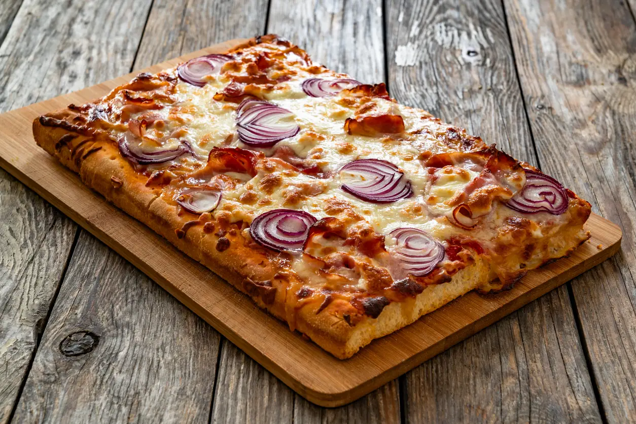 Pizza with bacon, mozzarella cheese and red onion drizzled with Sonoma Farm Bacon Infused EVOO