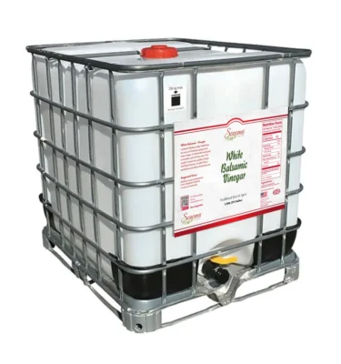 A large 275-gallon caged IBC tote filled with original white balsamic vinegar